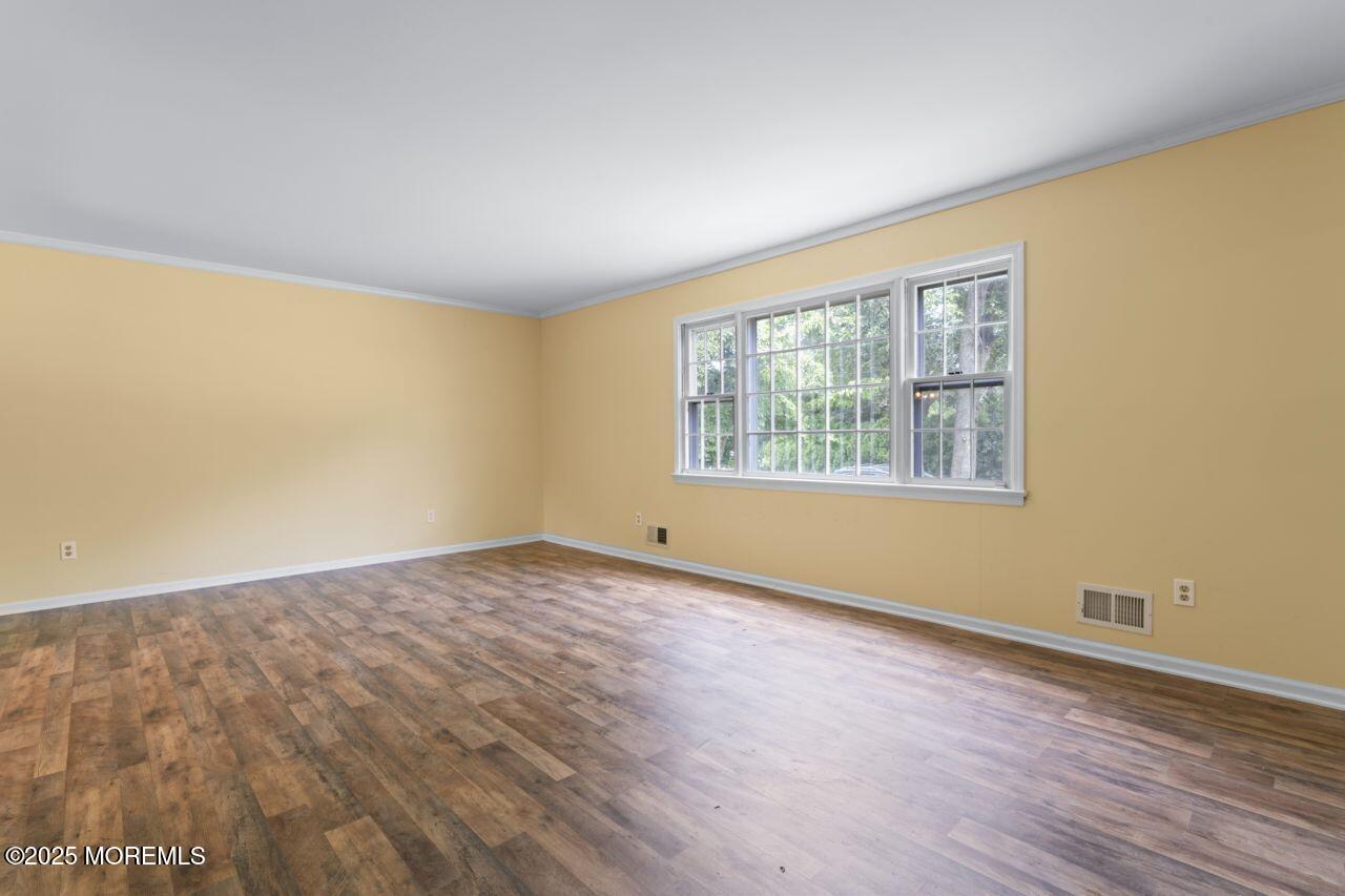 600 Driscol Drive Brick, NJ 08724 - Photo 16 of 35 a view of an empty room with wooden floor and a window