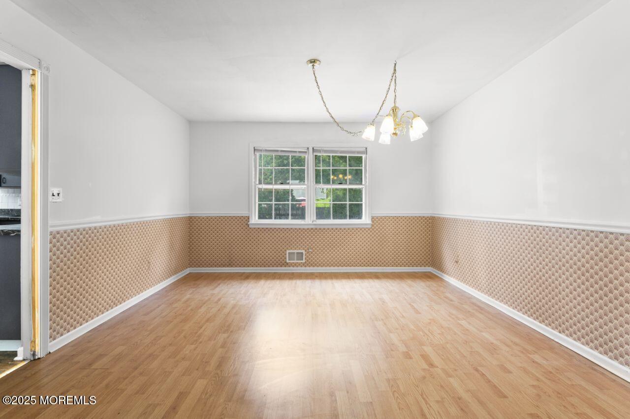 600 Driscol Drive Brick, NJ 08724 - Photo 18 of 35 a view of an empty room with wooden floor and a window