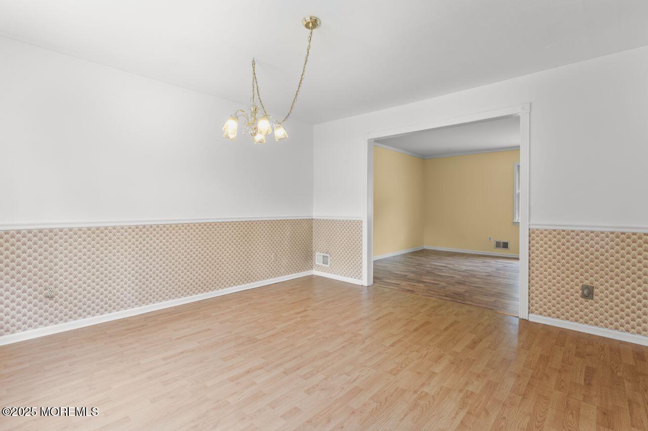 600 Driscol Drive Brick, NJ 08724 - Photo 19 of 35 an empty room with wooden floor and windows