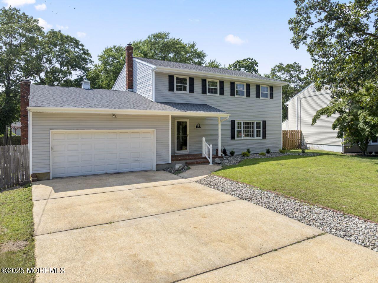600 Driscol Drive Brick, NJ 08724 - Photo 2 of 35 a front view of a house with a yard and garage