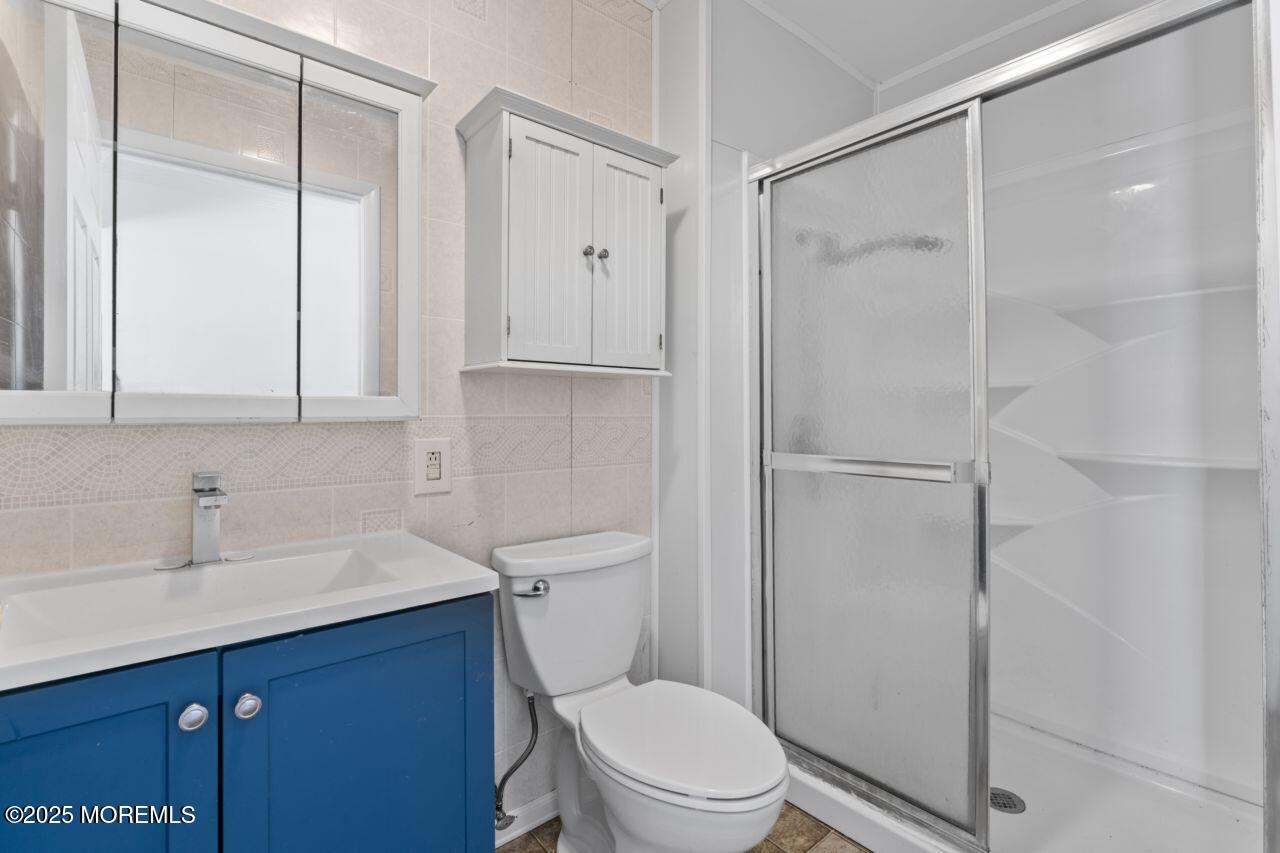 600 Driscol Drive Brick, NJ 08724 - Photo 21 of 35 a bathroom with a sink a toilet and shower