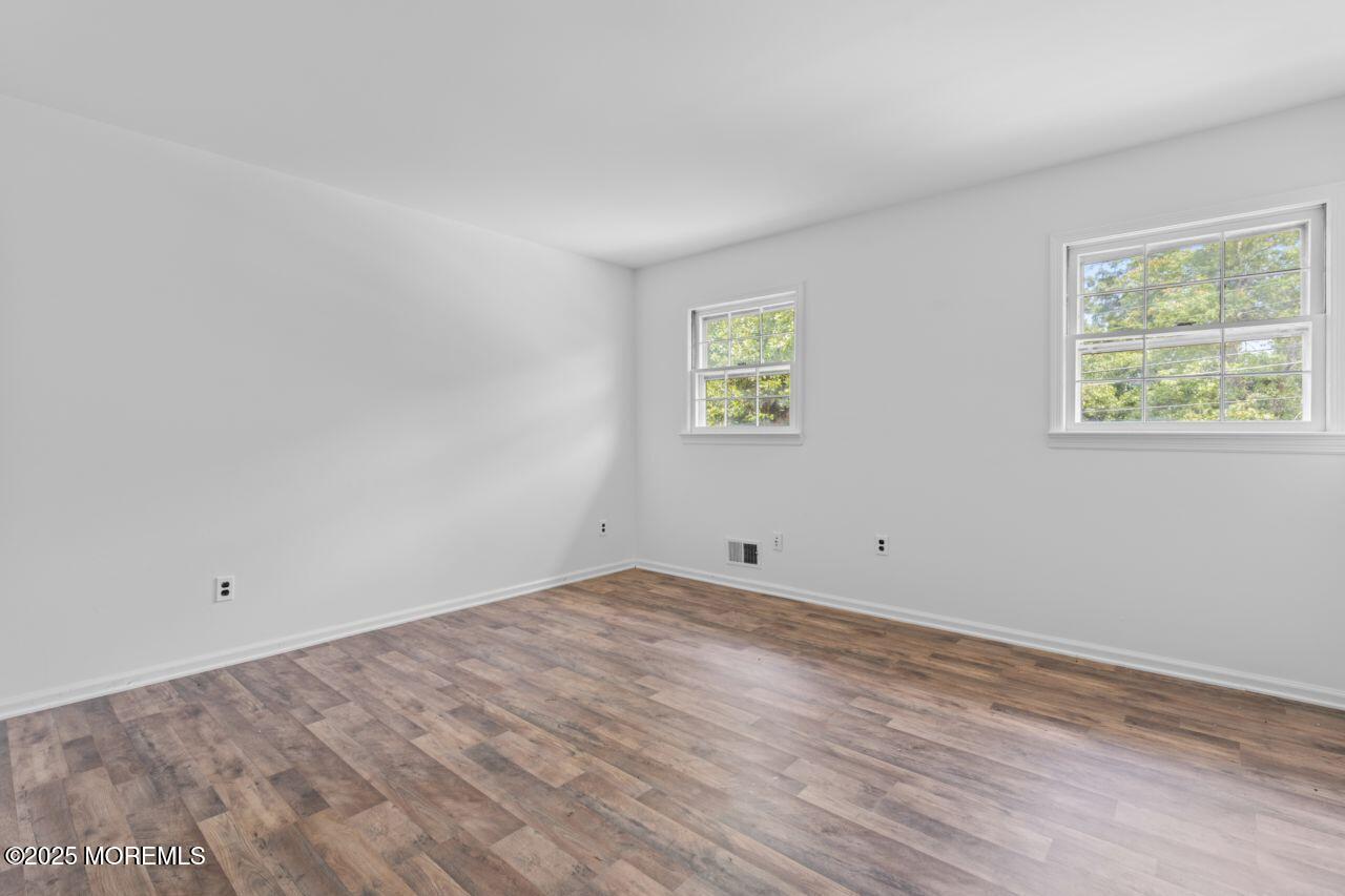 600 Driscol Drive Brick, NJ 08724 - Photo 22 of 35 wooden floor in an empty room with a window