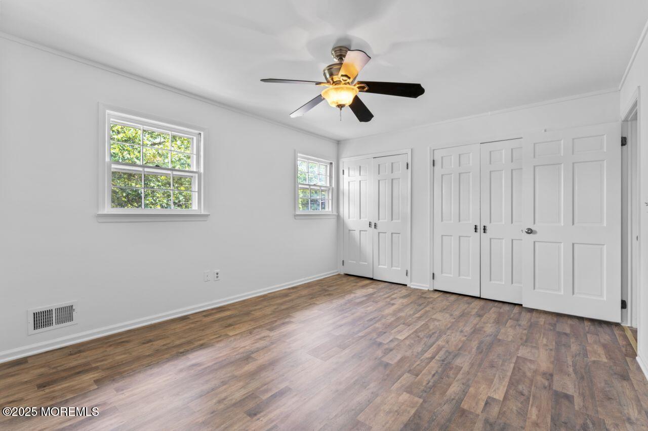 600 Driscol Drive Brick, NJ 08724 - Photo 25 of 35 a view of an empty room with wooden floor and window