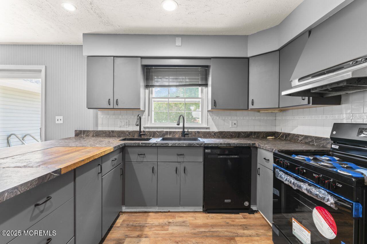600 Driscol Drive Brick, NJ 08724 - Photo 8 of 35 a kitchen with granite countertop a sink and a stove