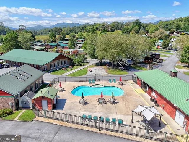 an aerial view of a swimming pool with a yard