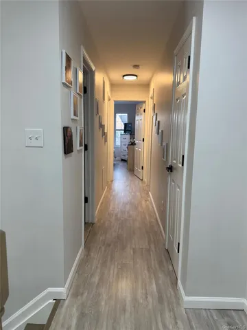 a view of hallway with wooden floor