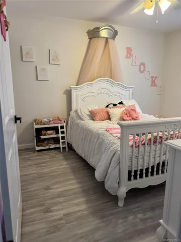 a bedroom with a bed and a baby crib