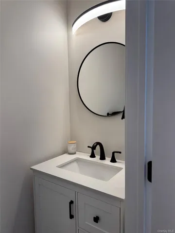 a bathroom with a sink and mirror
