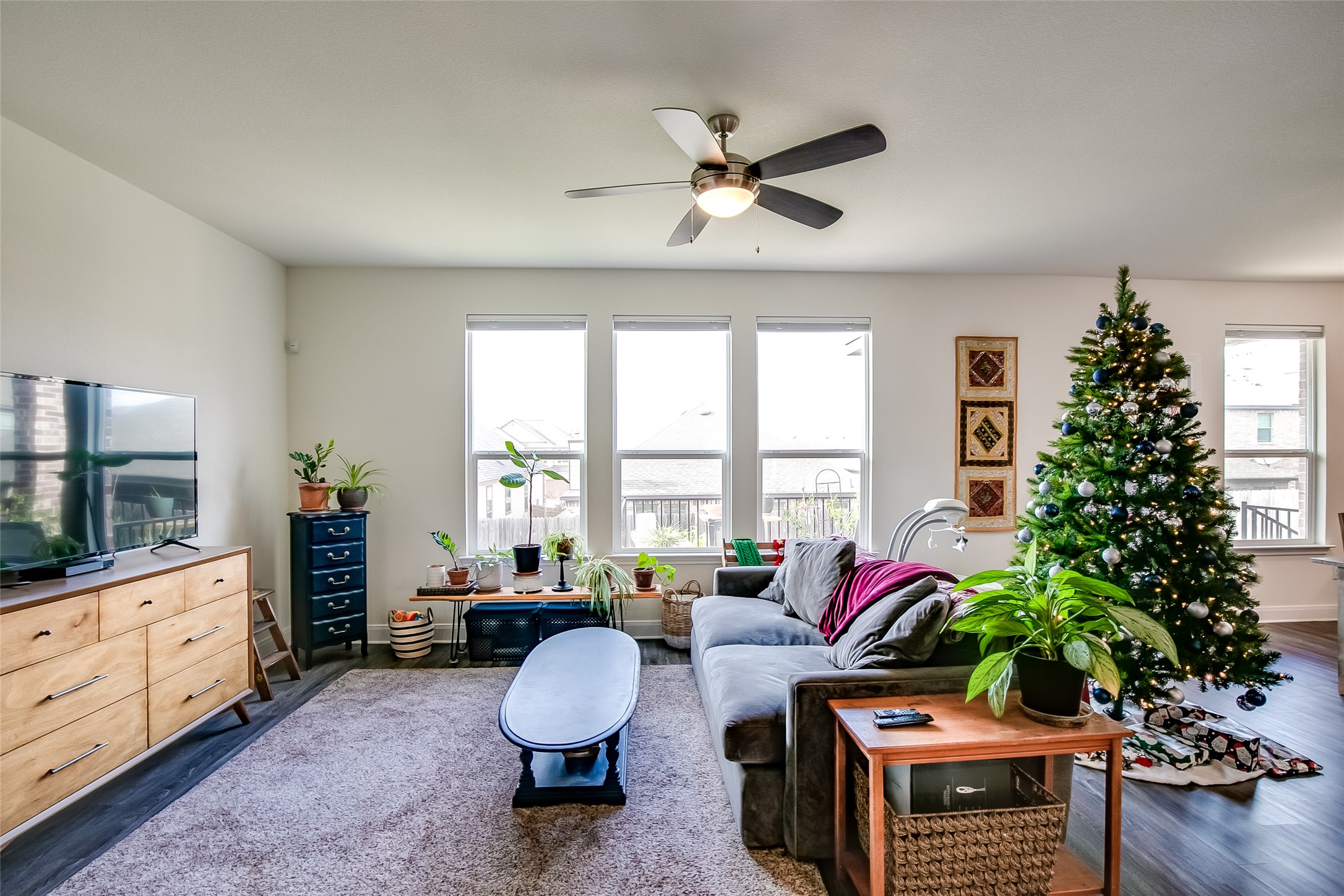 7616 Groundhog Way Austin, TX 78744 - Photo 7 of 34 a living room with furniture and a potted plant