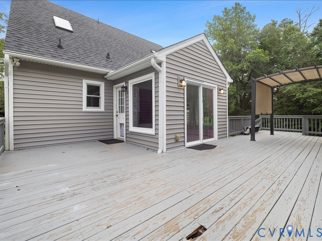 12230 Harrowgate Road Chester, VA 23831 - Photo 24 of 38 Spacious outdoor deck with a pergola, offering dir
