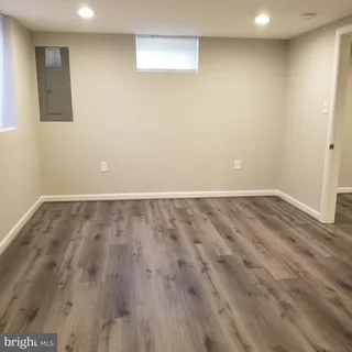 a view of room with window and wooden floor