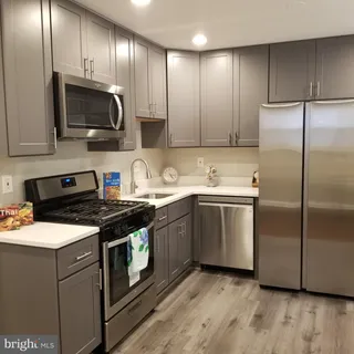 a kitchen with a sink stove and microwave