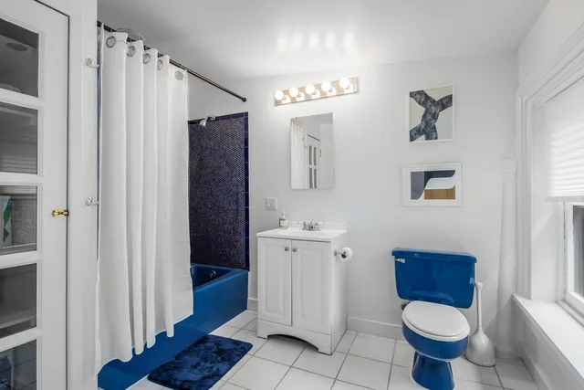 a bathroom with a toilet a sink and mirror