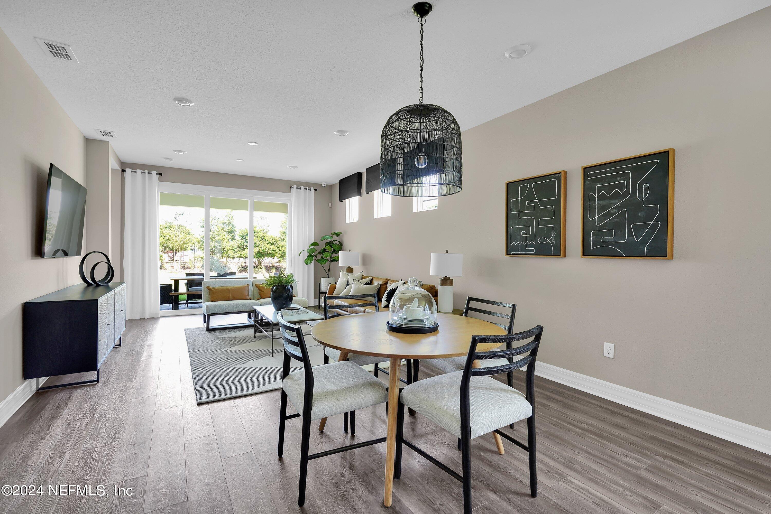 507 Goodwill Court Yulee, FL 32097 - Photo 3 of 38 a view of a dining room with furniture window and wooden floor