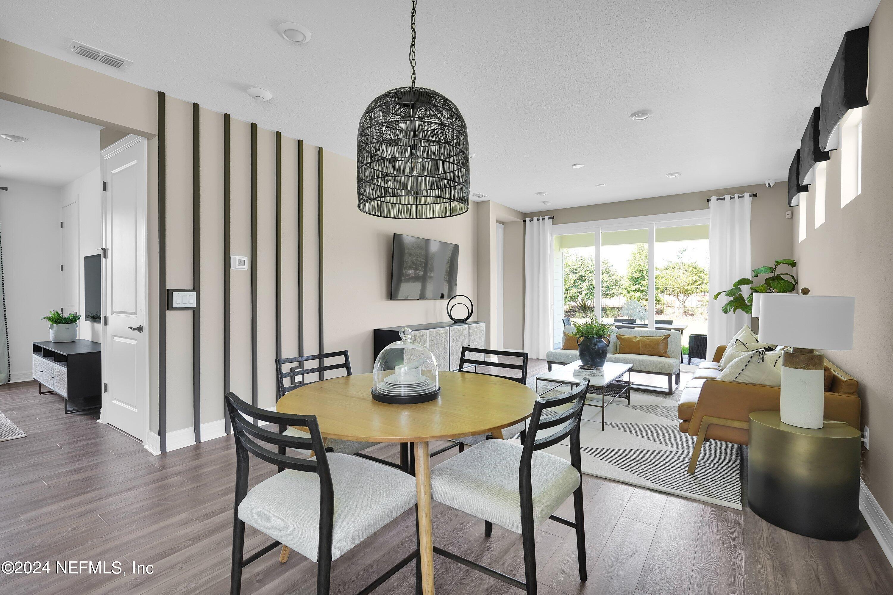 507 Goodwill Court Yulee, FL 32097 - Photo 4 of 38 a dining room with furniture and wooden floor