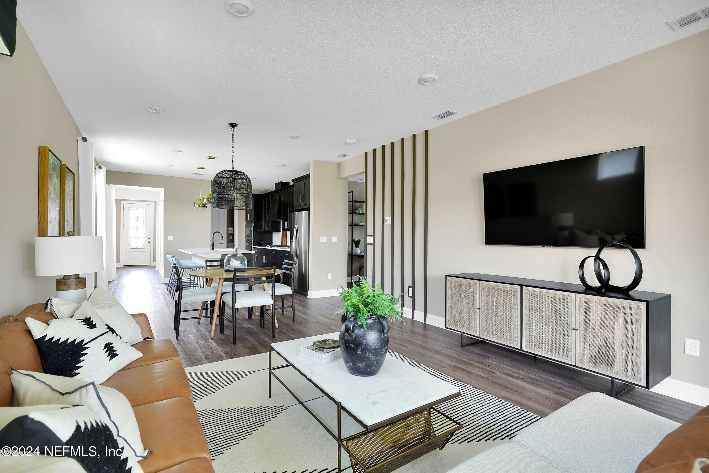 507 Goodwill Court Yulee, FL 32097 - Photo 7 of 38 a living room with furniture and a flat screen tv