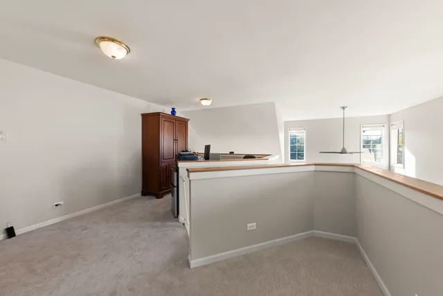 a view of an empty room with a kitchen