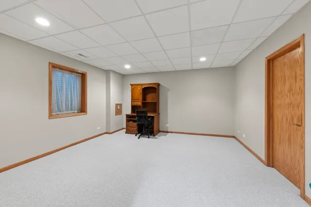 an empty room with furniture and a window