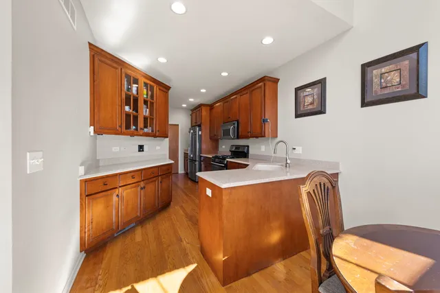 a view of kitchen with stainless steel appliances granite countertop sink stove and refrigerator