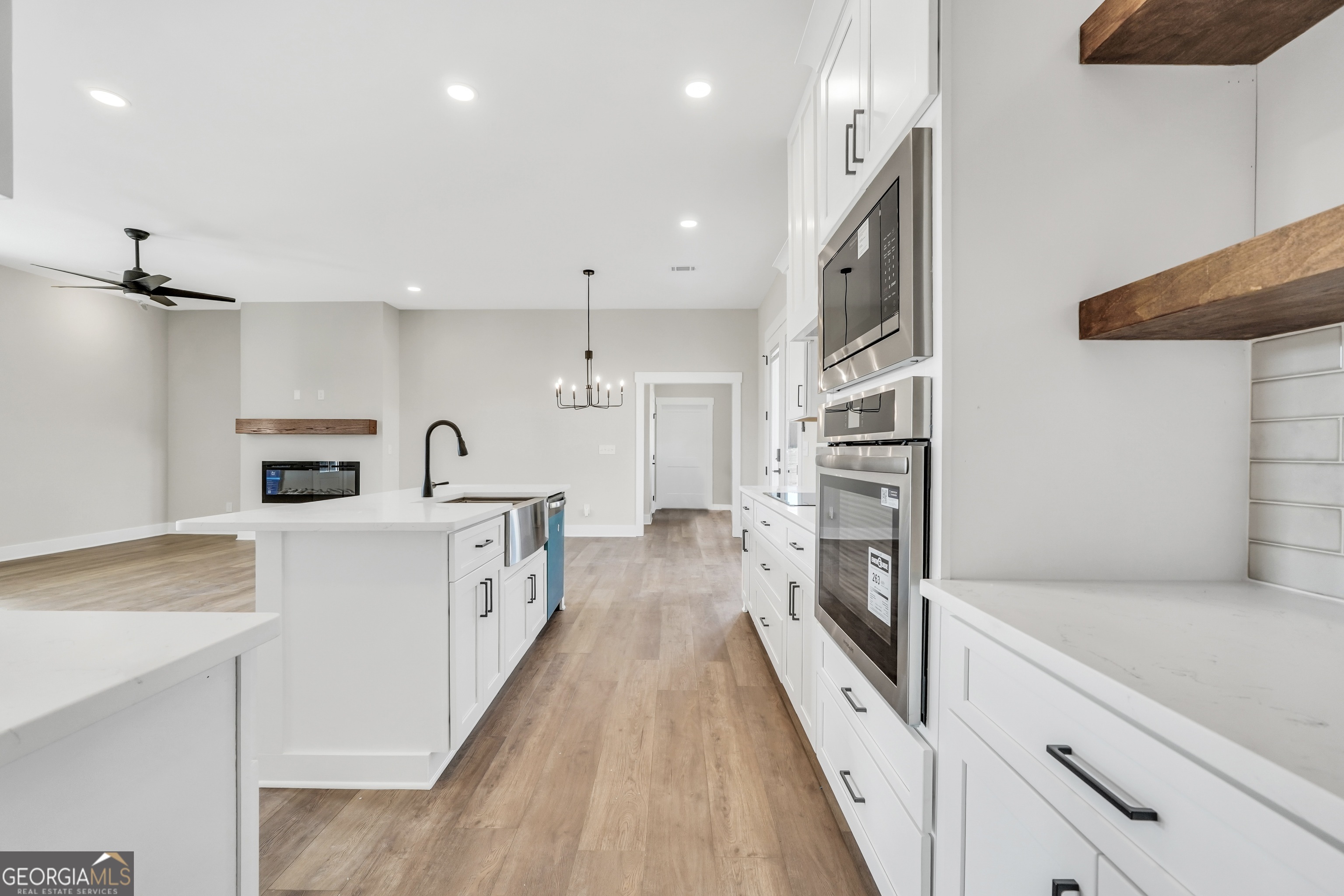 297 East Knight Road McDonough, GA 30252 - Photo 13 of 64 a large kitchen with stainless steel appliances lots of counter space and wooden floor