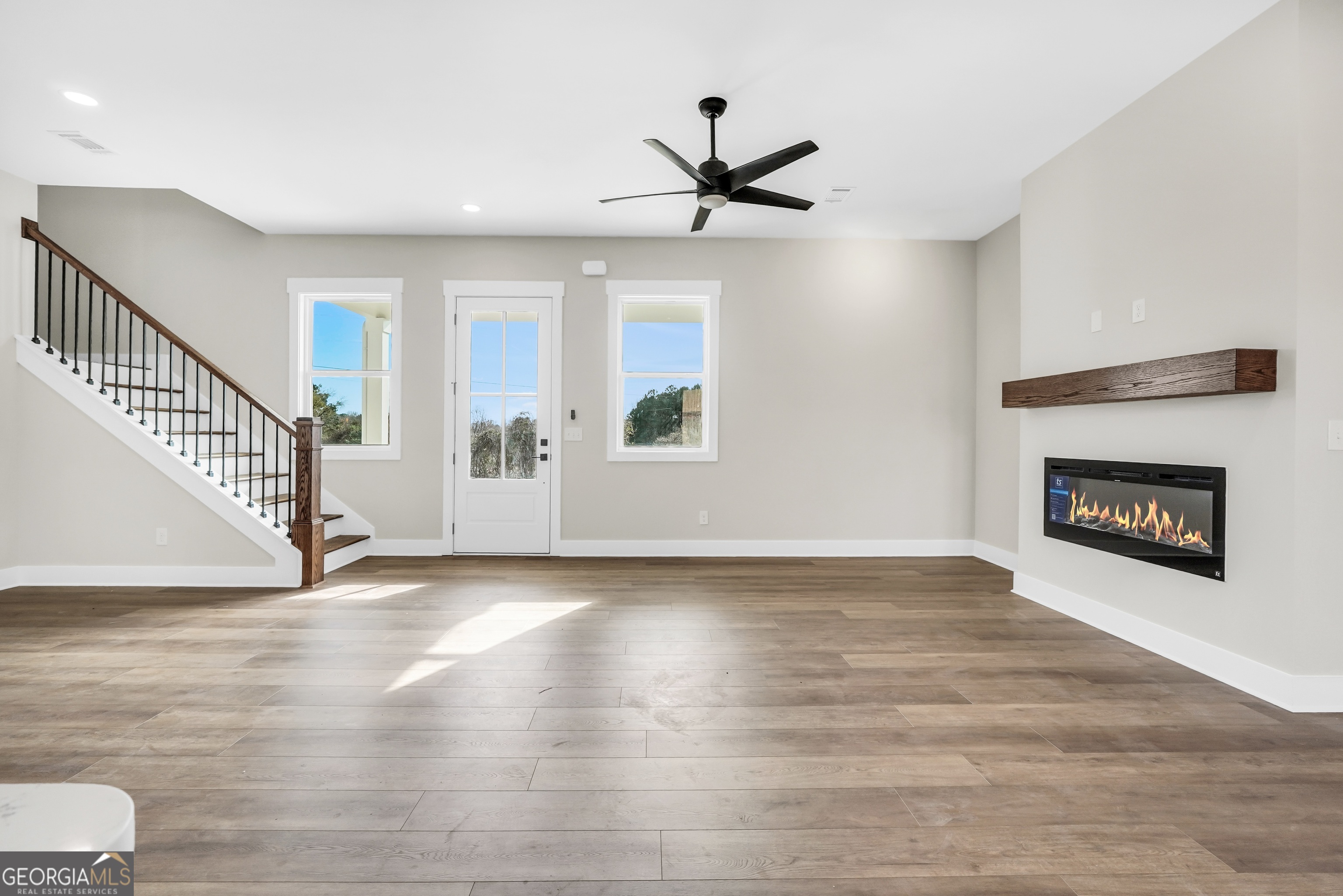 297 East Knight Road McDonough, GA 30252 - Photo 16 of 64 a view of an empty room with wooden floor fireplace and a window