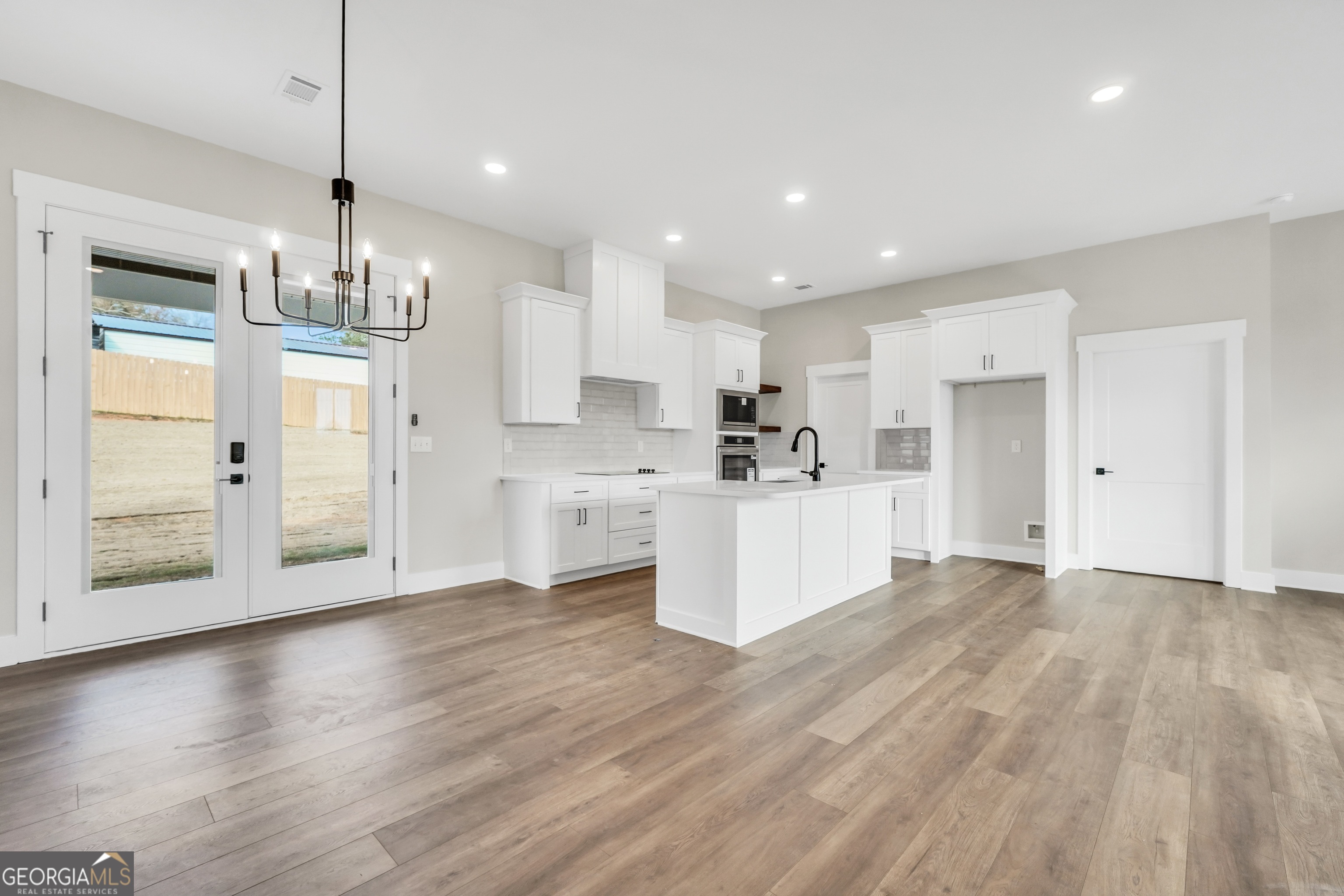 297 East Knight Road McDonough, GA 30252 - Photo 23 of 64 a view of a kitchen with refrigerator and wooden floor