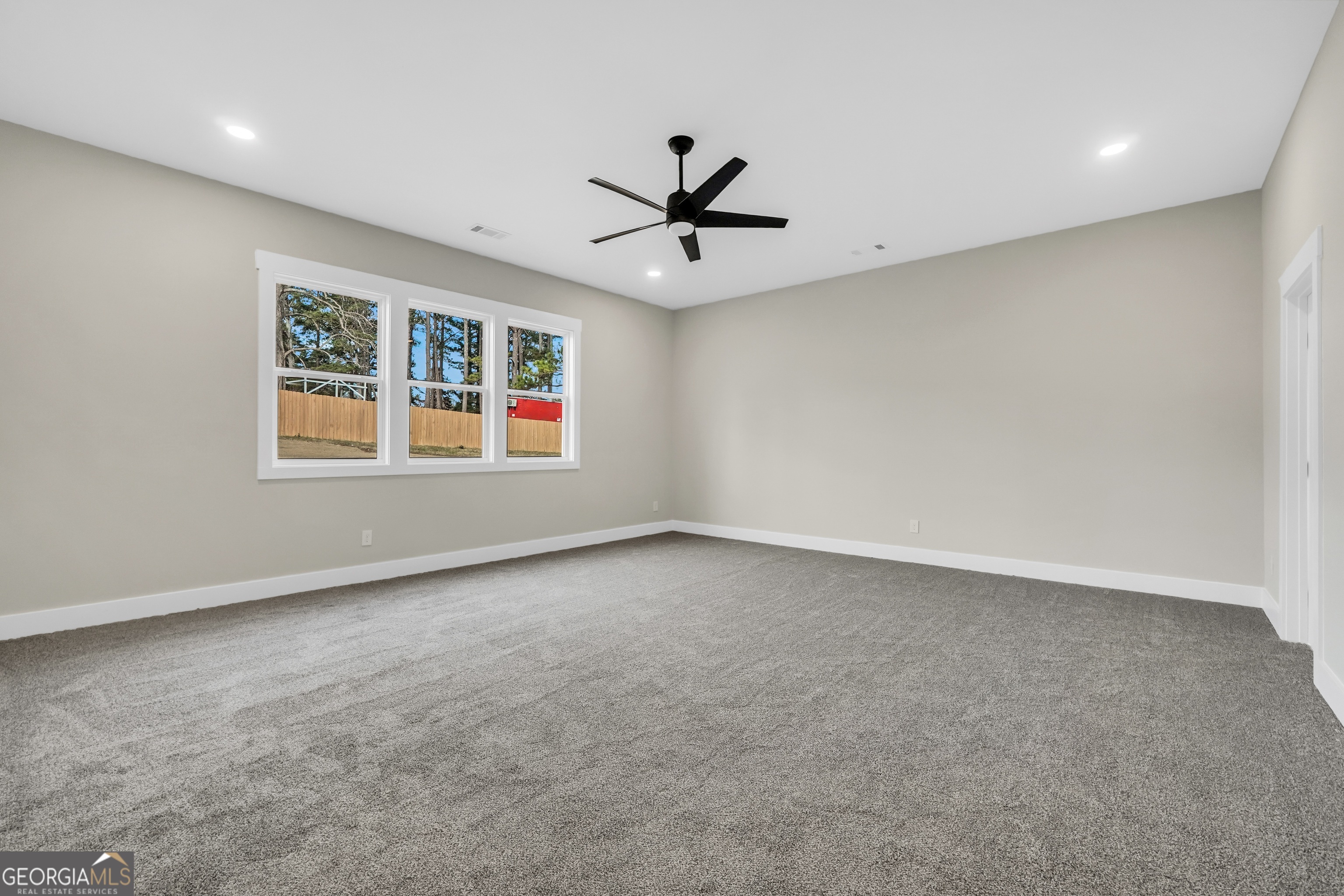 297 East Knight Road McDonough, GA 30252 - Photo 38 of 64 an empty room with windows and ceiling fan