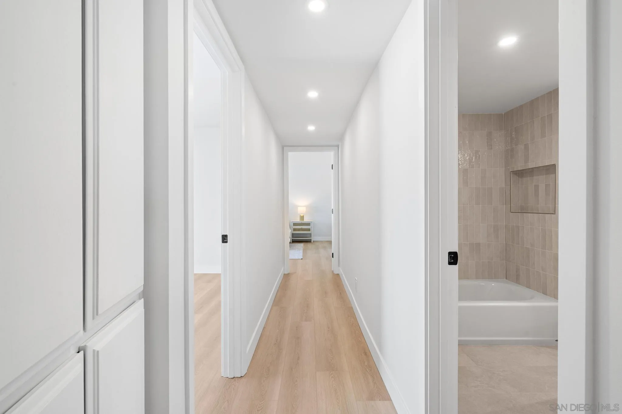 4242 Avenida Gregory Spring Valley, CA 91977 - Photo 33 of 53 a view of a hallway with wooden floor and a glass door