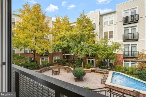 a view of a balcony with dining table and chairs with wooden floor