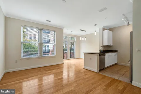 a kitchen with a refrigerator and a stove top oven