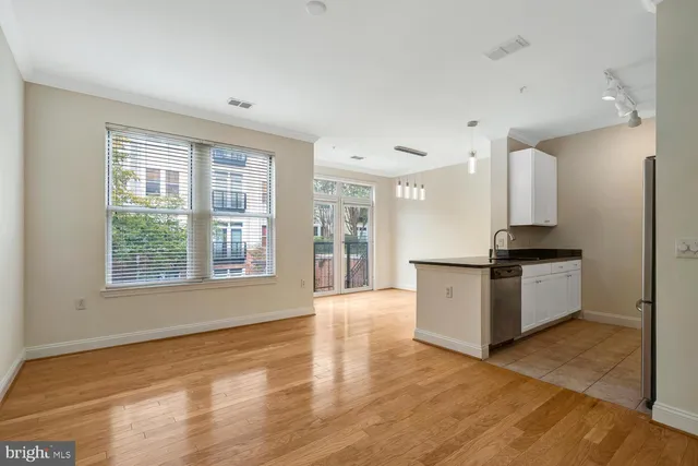 a kitchen with a refrigerator and a stove top oven
