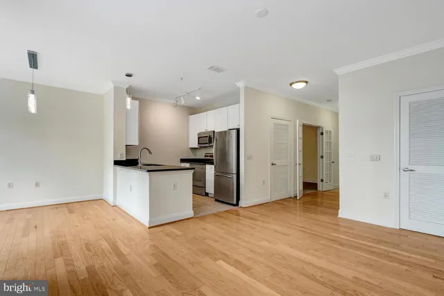 a view of a kitchen with a sink and a refrigerator