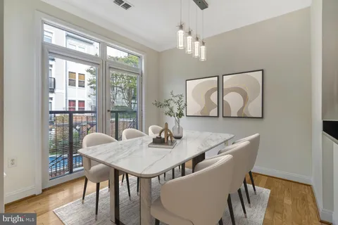 a view of a dining room with furniture window and wooden floor