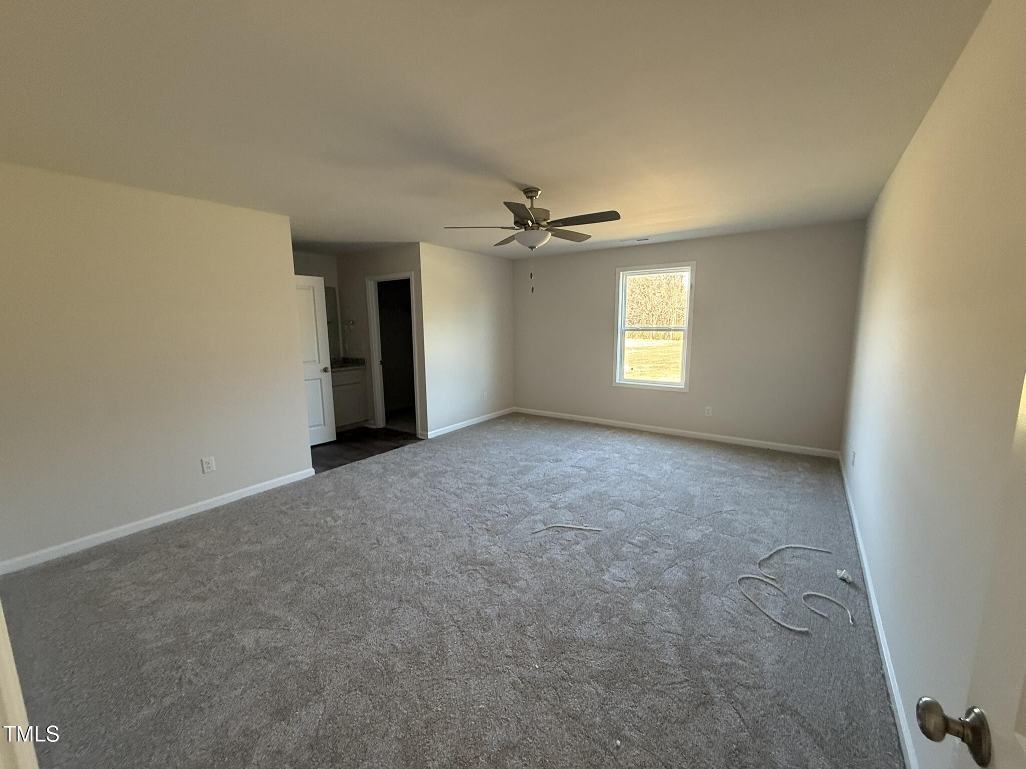 148 Phil Jack Road Dunn, NC 28334 - Photo 14 of 18 an empty room with windows and chandelier fan