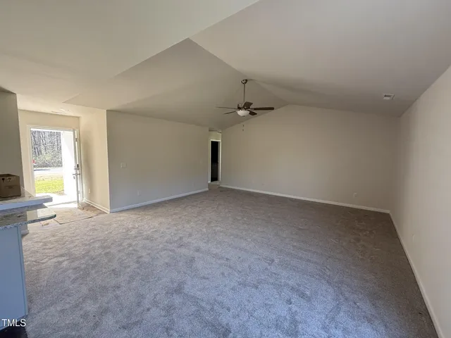 an empty room with a empty space and windows