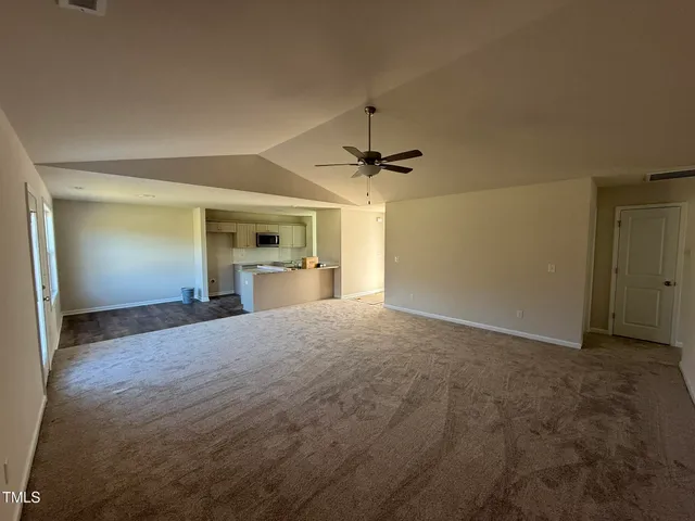 a view of empty room with a fireplace