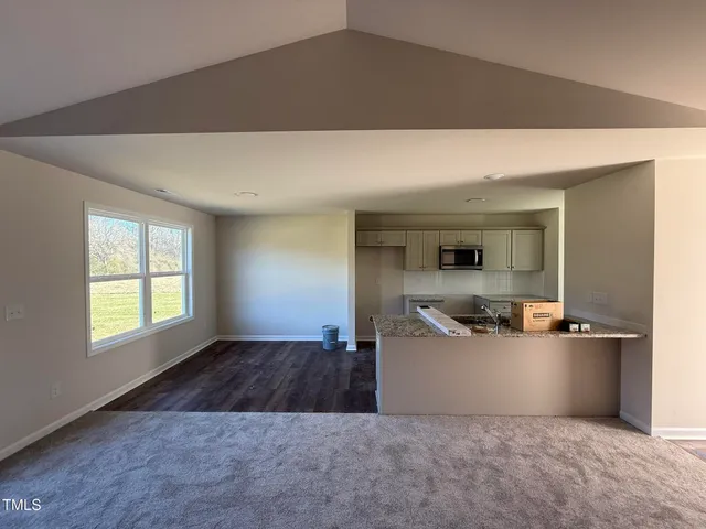 a view of a kitchen with a sink cabinets and a window