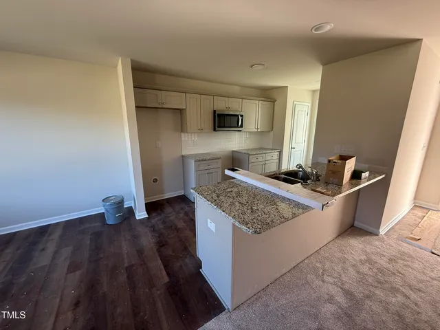 a kitchen with sink and refrigerator