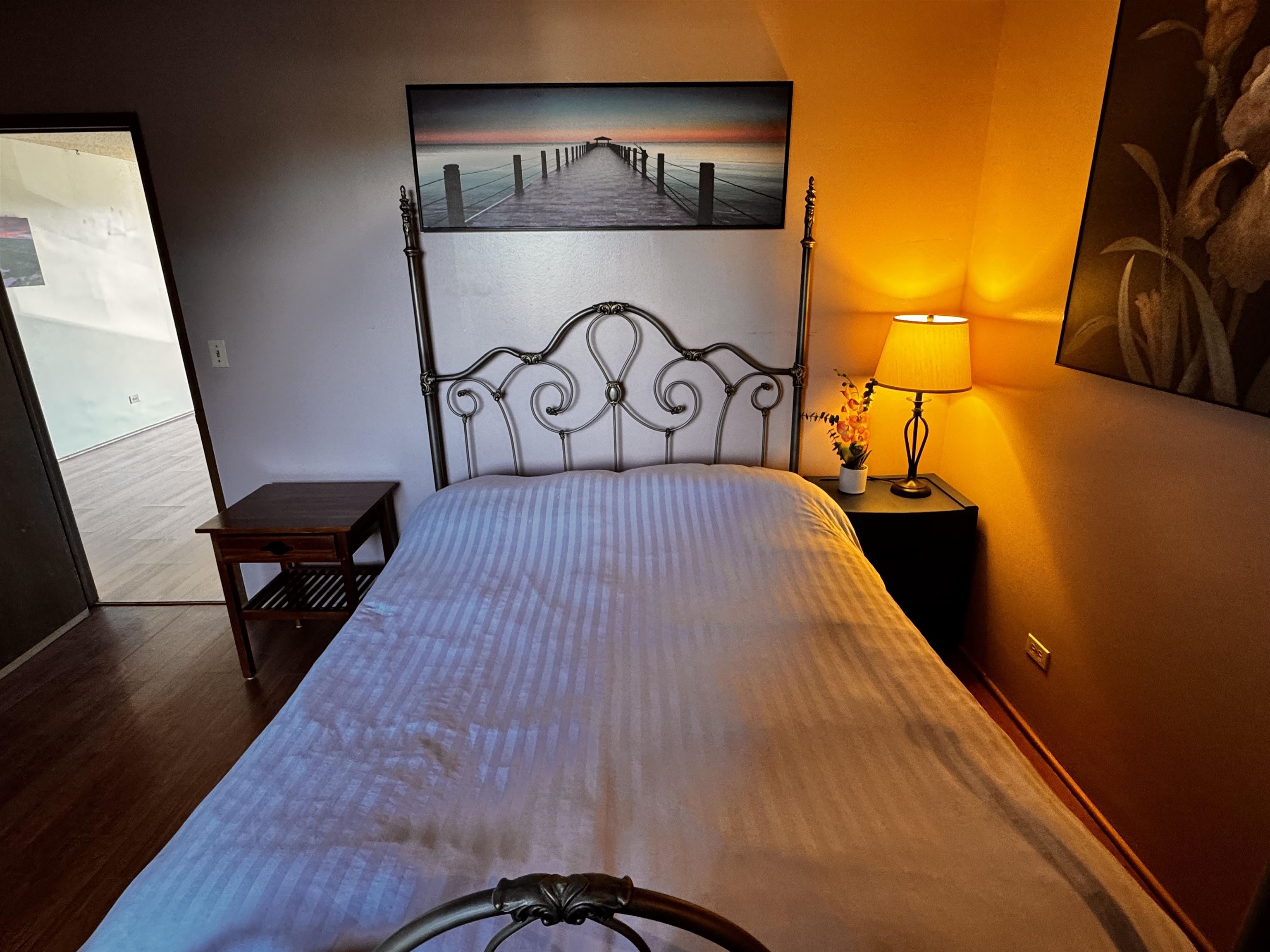 4310 Lower Honoapiilani Road, Unit 315 Lahaina, HI 96761 - Photo 12 of 20 a bedroom with a bed and wooden floor