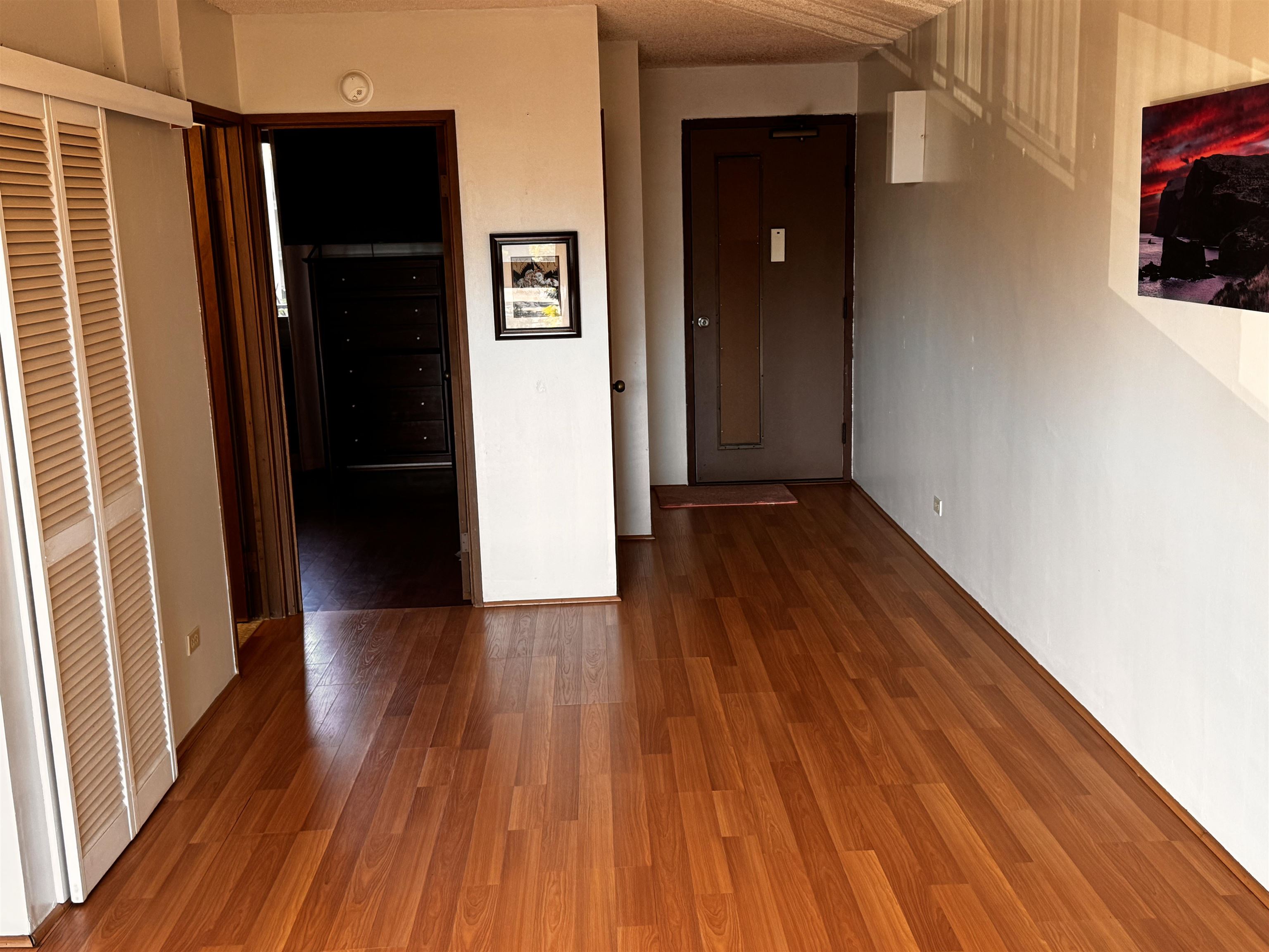 4310 Lower Honoapiilani Road, Unit 315 Lahaina, HI 96761 - Photo 7 of 20 a view of a hallway with wooden floor and staircase