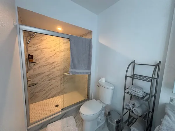 a bathroom with a toilet and a shower