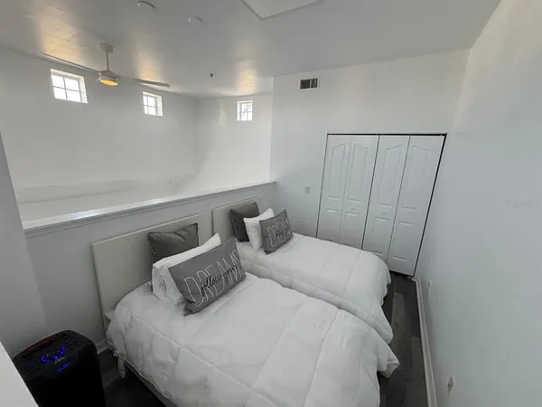 a bedroom with a bed and a window
