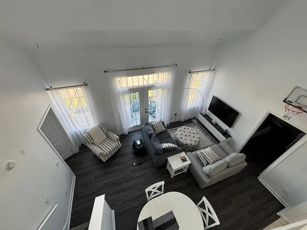 a living room with furniture rug and window