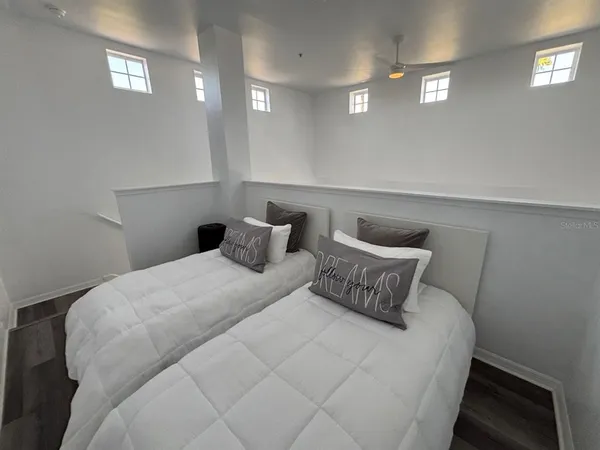 a bedroom with a bed and window