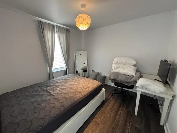 a bedroom with bed and a window
