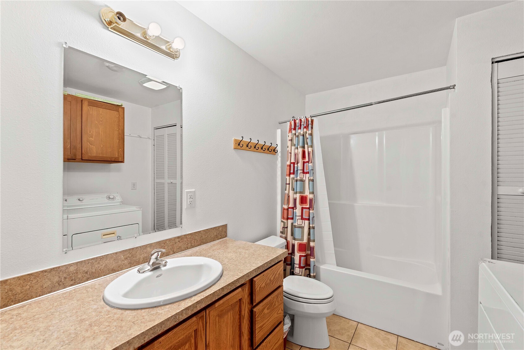 203 Marr Street Wenatchee, WA 98801 - Photo 11 of 22 a bathroom with a granite countertop sink toilet a mirror and shower