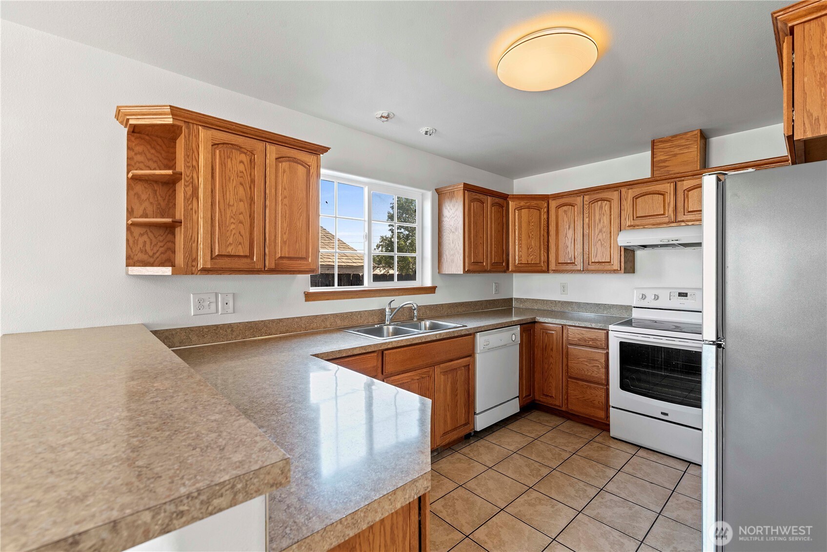 203 Marr Street Wenatchee, WA 98801 - Photo 6 of 22 a kitchen with stainless steel appliances granite countertop a sink and a stove
