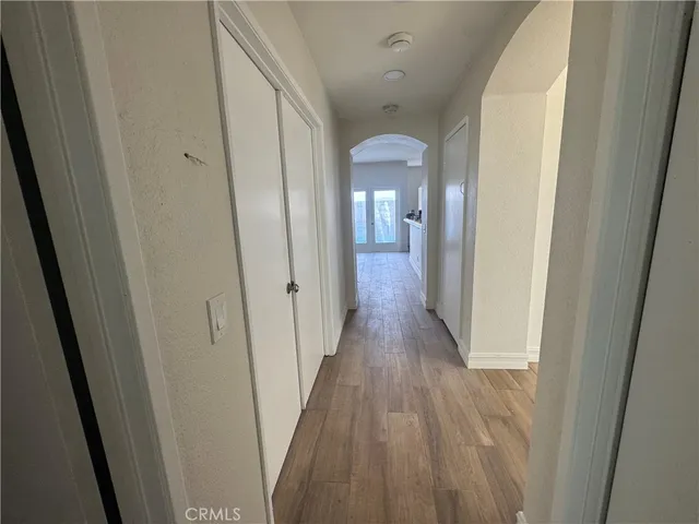 a view of a hallway with wooden floor