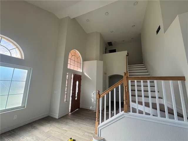 a view of entryway with stairs and wooden floor