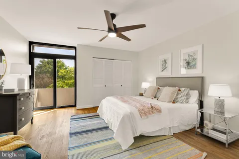 a bedroom with a large bed and a large window